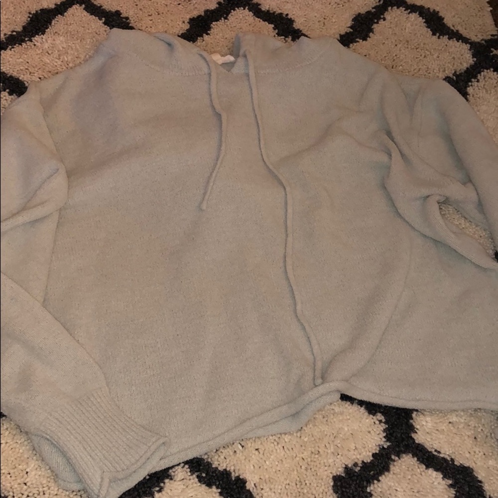 A cropped mint sweatshirt